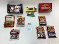 Overview of all 10 vehicles including trucks, cars, buses, and boat Mostly in original packaging with creases and some damage, two opened showing wear