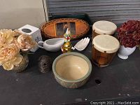 Overview of home decor items including cribbage board, bongo drums, ceramic clown figure, trinket box and dishes, ceramic pot, gravy boat, and artificial flower arrangement.