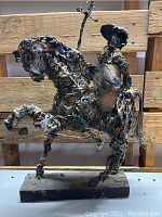 Front shot of the wire sculpture showing Don Quixote on horse with lance and shield, highlighting the structure and posture of the figure and horse.