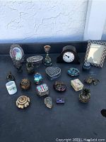 Wide view showing all trinket boxes laid out with clock and picture frames