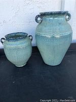 Two pottery vases placed side by side showing relative size and color