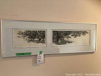 Overview of the framed art print showing two black and white tree images side by side in a long horizontal silver frame.