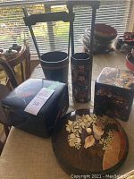 Photo showing all Japanese containers and serving dishes arranged on table near window.