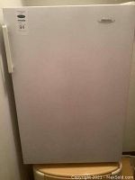 Photo of the front closed door of the white Danby mini fridge with a label showing 94 cm height.