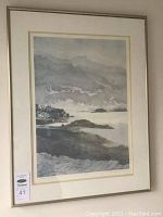 Full view of framed black and white coastal landscape print with silver frame and double mat.