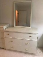 Front view of white 3-drawer dresser with mirror attached behind
