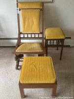 Front-facing photo of the glider rocker chair, footstool, and side table showing yellow corduroy cushions and wooden frames.