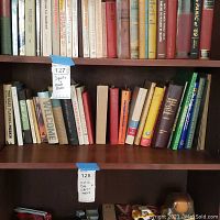 Shelf of assorted books focusing on sports and general themes with partly visible titles.
