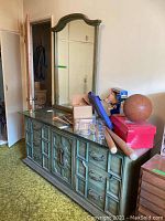 Photo of the vintage dresser with mirror showing full front and contents on top