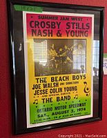 Front view of framed concert poster showing full colorful text and graphics.