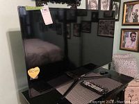 Samsung 40-inch TV on a table with the screen off, showing the black frame and stand.