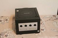 Front view of black Nintendo GameCube console showing four controller ports and two memory card slots.