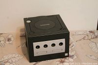 Front view of black Nintendo GameCube console showing the four controller ports and two memory card slots.
