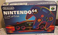 Front of original Japanese Nintendo 64 box with rainbow-outlined console and controller graphics.