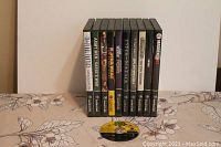 All GameCube game cases lined up showing spines and titles, with one loose disc on table.