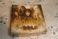 Closed game box with cover featuring Lord of the Rings characters and title.
