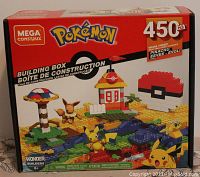 Front of the Mega Construx Pokemon Building Box showing the 450-piece set with Pikachu and Eevee figures, a Pokeball, and other buildable elements on display.