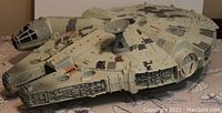 Side angle photo of the Millennium Falcon toy showing exterior details and satellite dish on top.