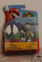 Front view of unopened Super Mario Winged Dry Bones figure in original packaging with two detachable wings.