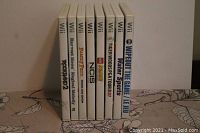 Photo showing 8 Nintendo Wii game cases lined up side by side, titles visible from the spine.