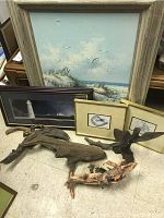 Lot arranged on floor showing large oil painting of beach scene, three framed drawings, driftwood pieces and metal bird sculpture
