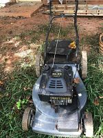 Front view of Craftsman Eager-1 lawn mower on grass showing metal deck, wheels, handlebar, and pull start cord.