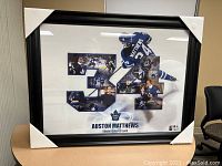 Framed print of Auston Matthews with number 34 made up of multiple images including the player in action wearing the blue Toronto Maple Leafs uniform, set in a black frame with white matte.