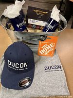 Galvanized tub with two navy Ducon branded mugs and MacKinnon Brothers Brewing Co $65 gift certificate displayed inside