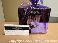 Purple cellophane-wrapped Redken products kit and printed gift certificate