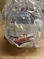 Front view of cellophane-wrapped basket showing envelope, tubes, mitt and samples