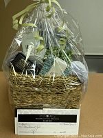 Front view of fully assembled basket with cellophane wrap and voucher visible