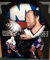 Signed Billy Smith photo with career achievements and statistics from his time with the New York Islanders, showing multiple images of him in goalie gear and inscription in silver ink.