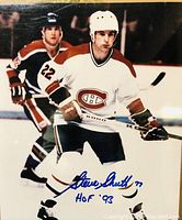 Color action shot of Steve Shutt skating in Montreal Canadiens uniform, signed by Steve Shutt with HOF 1993 inscription.