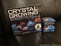 Front of main 4M Crystal Growing Experimental Kit box with refill box beside it on a leather couch.