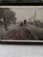 Framed black and white historic photo showing Queen St Viaduct with streetcar and pedestrians crossing tracks dated Oct 16 1913.