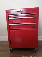 Front view of closed tool cabinet showing three drawers and lower cabinet