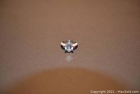 Front view of silver ring size 7 with large round clear center stone and small accent stones on sides of the band