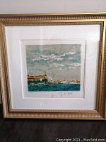 Full view of the framed art print depicting a Venetian scene with a gold frame and white mat.
