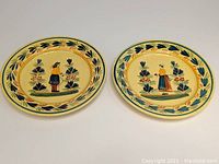 Two Henriot Quimper plates side by side, showing overall size and decoration with Breton man and woman.