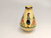 Front view showing Breton man motif with floral elements on a yellow background.