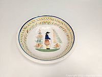 Top-down view showing the Breton man figure and decorative leafy border inside the bowl