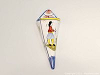 Front view of the Henriot Quimper wall pocket vase showing hand-painted Breton man in traditional costume with red, blue, yellow and black colors