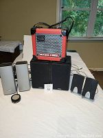 Front view of Roland Micro Cube amplifier, Micca MB42 bookshelf speakers, Bose Companion 20 satellites with control pod, and generic computer speakers