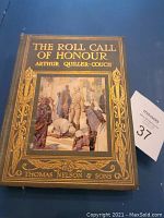 Front cover of The Roll Call of Honour book showing embossed gold text and a colored illustration framed in gold.