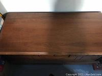 Top view of closed cedar chest showing medium brown stained wood surface