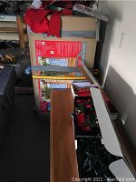 Boxed artificial Christmas tree and wreath box on table