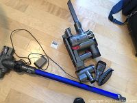 Full lot on floor showing vacuum unit, wand, motorized floor head and attachments