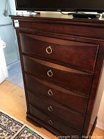 Front view of highboy dresser showing five drawers and ring pull handles