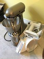 Tilt-head mixer with bowl and attachments arranged