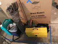 Photo of all camping gear items showing the hard cases, coolers, camping chair, and water container